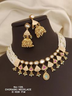 Description :- White Kundan Pearl Necklace Set/ Kundan Choker/Bollywood Jewelry/Indian jewelry/ Pakistani necklace/ punjabi necklace/bridal /indian wedding Gift yourself a royal look with this perfectly crafted kundan necklace set from Manalisstudio. Crafted with high quality kundan stones and pearls, it is impressive in design. The green enamel artwork adds perfect texture to the design. Perfect for weddings and festivities, this antique necklace set should be put on with your favorite sari or Luxury Temple Jewelry Choker As Gift, Bollywood Necklaces With Latkans For Wedding, Bollywood Style Necklaces With Latkans For Wedding, Bollywood Style Wedding Necklaces With Latkans, Bollywood Style Necklace With Latkans For Wedding, Bollywood Jewelry Sets For Diwali Reception, Bollywood Style Heavy Pearl Necklace For Diwali, Meenakari Kundan Necklace For Reception, Bollywood Style Meenakari Kundan Necklace For Reception