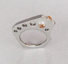 Unique modern design ring in sterling silver with two tube set topaz, one opposite each other through the ring. Diamonds and topaz set on the top of the ring. The ring fits comfortably against your pinky if worn on the ring finger and against the ring finger if worn on your pinky! Modern Topaz Ring With Center Stone For Anniversary, Modern Silver Diamond Birthstone Ring, Modern Open Topaz Ring, Modern Sterling Silver Topaz Ring For Formal Occasions, Modern Topaz Ring With Diamond, Modern Silver Diamond Sapphire Ring, Modern Silver Birthstone Ring With Center Stone, Modern White Topaz Ring With Center Stone, Modern Topaz Ring With Diamond And Polished Finish