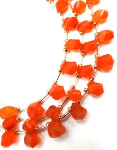 an orange necklace on a white background