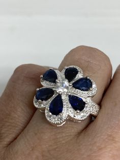 Unusual Deep Toned Sapphire Sterling Filigree Setting Handmade Size 6.25 Can be resized My jeweler charges $10-$20 All rings are shipped in a nice gift box. Check out our over a THOUSAND great reviews Engraving is $4 per letter and is not always perfect depending on the piece. It can take a few days if the jeweler is busy. This is payable to Paypal Judithsltd@gmail.com Blue Flower-shaped Formal Jewelry, Sapphire Flower-shaped Jewelry For Gifts, Sapphire Flower-shaped Jewelry Gift, Sapphire Flower Shaped Jewelry For Gifts, Flower Shaped Sapphire Jewelry Gift, Blue Gemstone Flower Ring, Blue Flower Ring For Anniversary, Sapphire Flower Jewelry For Gifts, Blue Flower Rings For Formal Occasions