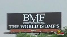 a billboard with the words b m f on it in front of some palm trees