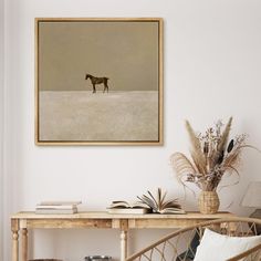 a horse is standing in the snow near a table with books and plants on it