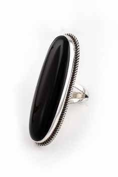 This Long Oval Black Onyx Ring (Size 6.75) is stunning. Famous Zuni artist, Viola Eriacho, created this dramatic sterling silver and black onyx ring that is sure to make a statement. A large long oval stone is bezel set in hand-stamped sterling silver and surrounded with a rope twist. Long oval shapes make fingers appear slender and provide a sophisticated style. Wear this distinctive ring with your little black dress and you’re set to go in style. Lightly oxidized and polished for a beautiful l American Rings, Native American Rings, Silver Eagle, American Indian Jewelry, Rope Twist, Silver Eagles, Black Onyx Ring, Onyx Ring, Oval Stone