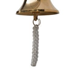 a brass bell hanging from a chain with a white bead ball on it's end