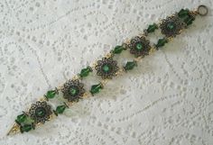 "This beautiful bracelet has seed beads, green Czech glass beads, antique gold accent beads and antique gold filigree settings accented with rhinestones. 7\" long. Toggle clasp." Jewelry Art Nouveau, Victorian Bracelet, Bracelet Art, New Plymouth, Green Bracelet, Art Deco Bracelet, Nouveau Jewelry, Art Nouveau Jewelry, Gothic Victorian