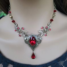 "This vintage medieval styled crystal necklace features luscious Scarlet colored Austrian crystals with nice crisp facets and brass embellishments.  Rich with elegance, this piece would be perfect for a moonlit date night, medieval fair and countless formal events. The necklace focal point, along with the drop crystal, measures approximately 2\" long and 1-1/2\" wide. The brass chain is 18\" long and can be shortened by hooking the lobster clasp onto any of the 4x6mm cable chain links for a cust Necklace Vampire, Vamp Goth, Medieval Necklace, Vampire Necklace, Vampire Jewelry, Medieval Fair, Red Crystal Necklace, Gothic Medieval, Earrings Gothic