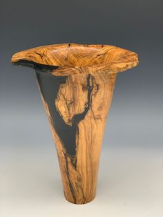 a wooden vase sitting on top of a table