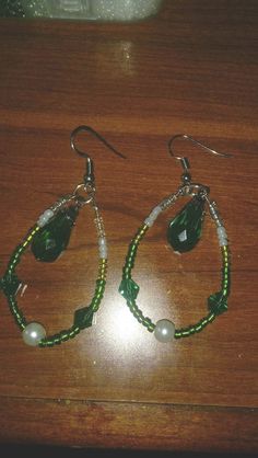 I made the original pair of these for my mother to wear for my wedding. They are lovely and elegant and she looked beautiful wearing them as anyone else would. I use a green pear shaped crystal bead circled by a string of glass seed beads, pearls and crystal beads. The ear hooks are silver and drop to about 1.5 inches total. I also include plastic earring backs and they are placed in a gift box before being shipped. These are great for weddings and any other special occasions. Ask about getting Green Beaded Earrings With Dangling Beads For Wedding, Green Teardrop Jewelry With Pearl Drop, Green Teardrop Beaded Earrings For Party, Pearl Beaded Teardrop Earrings, Teardrop Beaded Crystal Earrings For Wedding, Handmade Green Crystal Earrings For Wedding, Green Teardrop Pearl Drop Jewelry, Wedding Teardrop Beaded Crystal Earrings, Teardrop Crystal Jewelry With Dangling Beads