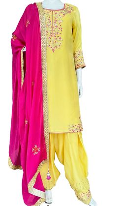 Lime yellow and pink upada silk suit. Kurta: Salma, sequins and thread work hand embroidery on neck and hem slits corners.  Sleeves having a wide border of embroidery. Fabric: Pure upada silk with shantoon lining. Salwar: Full flare Patiala Salwar made with 5 mtrs of fabric , with beautiful embroidery on hem /poucha .   Fabric: Pure upada silk Dupatta : Pure chinon pink color hand embroidery motif all over dupatta, with sequins border and matching handmade tassels. Width :40 inches Length : 2.25 Yellow Silk Sharara With Dabka Work, Yellow Semi-stitched Raw Silk Kurta, Yellow Silk Churidar With Gota Work, Yellow Raw Silk Kurta With Dori Work, Yellow Art Silk Kurta With Gota Work, Yellow Silk Salwar Kameez With Gota Work, Yellow Silk Sharara With Dupatta, Bollywood Style Yellow Silk Kurta, Yellow Dola Silk Kurta With Gota Work