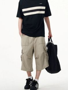 Embrace practicality with a touch of streetwise style in our Cargo Pocket Knee-Length Capri Shorts, designed for the modern man. Crafted with utmost attention to detail, these knee-length shorts feature a robust fabric blend that's pre-washed for a lived-in feel. The multiple cargo pockets not only enhance the utilitarian appeal but also add a layer of functionality, perfect for keeping your essentials at hand. The straight, loose fit ensures ease of movement and comfort throughout your day. Whe Casual Relaxed Fit Cargo Pants With Built-in Shorts, Sporty Summer Cargo Pants With Multiple Pockets, Casual Knee-length Pants With Pockets, Casual Khaki Pants With Built-in Shorts, Sporty Bermuda Bottoms With Cargo Pockets, Urban Style Khaki Pants For Summer, Casual Bermuda Cotton Pants, Knee-length Khaki Cotton Bottoms, Summer Knee-length Cargo Pants With Built-in Shorts