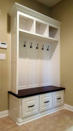 a large white coat rack with musical notes on the top and two bins below it