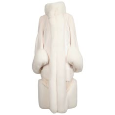 Very rare and dramatic off-white fur coat made of mink, fox and lamb fur from Alexander McQueen. Labeled an Italian size 42. Approximate measurements: shoulder 16", bust, waist and hip are open due to cape like design at back. Sleeves are very full. Hidden fur hooks at front. Quilted silk lining. Made in Italy. Excellent condition.