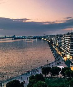 the city is next to the water at dusk