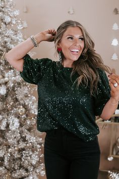 Spread more cheer in our Half Puff Sleeve Sequin Top in a festive green. This stylish top features eye-catching sequins and playful half puff sleeves, adding a touch of glamour to your winter and festive ensembles. Whether you're dressing up for a holiday party or adding flair to a casual look, the More Cheer Sequin Top ensures a statement of style. Green sequins detailing Lining Peek-hole + button closure Half balloon sleeve 100% polyester Imported Model Specs: Karli is wearing a size small in Comfy Christmas Outfits, Jollywood Nights, Half Puff Sleeve, Christmas Outfit Aesthetic, Green Velvet Top, Style Wide Leg Jeans, Bride Top, Casual Party Outfit, Christmas Party Outfits