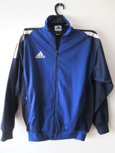 "Vintage Blue Adidas Jacket Blue Adidas Zipper Running Jacket Unisex Jogging Parka Blue Soccer Jacket Three Stripes Size Large Adidas Cardigan Label size: D 176; GB 34/36; F 16A Measurements: (lying flat) Length - 28.5\"/ 72.5 cm Shoulders: 20\"/ 51 cm Pit to pit: 22.5\"/ 57 cm Waist: 19.5\"/ 49.5 cm Sleeve: 22.5\"/ 57 cm Please check measurements to insure a proper fit. Remember to allow yourself some extra room for movement. You can compare these with something from your closet that fits you w Dress 70s Style, Adidas Jumper, 70s Fashion Dresses, Mens Summer Pants, Soccer Jacket, Checkered Pants, Festival Pants, Plaid Trousers, 90s Mens