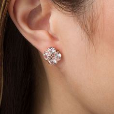 With a touch of floral charm, these lovely stud earrings are sure to become an instant favorite. Crafted in precious 10K rose gold, each pretty earring showcases a quartet of 5.0mm lab-created shimmering white sapphires. The sculpted flower-shaped center design sparkles with a diamond accent. Buffed to a brilliant luster, these post earrings secure comfortably with friction backs. Elegant Rose Gold Cubic Zirconia Flower Earrings, Elegant Rose Gold Flower Shape Cluster Earrings, Rose Gold Flower-shaped Cubic Zirconia Earrings, Rose Gold Cubic Zirconia Flower Earrings, Rose Gold Flower-shaped Earrings For Anniversary, Rose Gold Flower-shaped Earrings With Prong Setting, Elegant Rose Gold Cluster Earrings With Prong Setting, Rose Gold Cluster Flower-shaped Earrings For Gift, Rose Gold Flower Shaped Earrings With Prong Setting