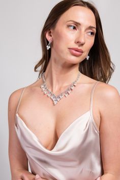 Our Megan Glam Cubic Z Necklace Set is designed to elevate and enhance any look. The statement Necklace is detailed with an all around semi stones and rhinestone design, the adjuster allows you to wear this to your best fitting. Its the perfect everyday piece. SizeLength : 14 in.Extender : 4.5 in. Drop : 1.25 in. QualityOne Size. Adjustable fit. Oxidized Metal Coating for quality endurance. ImportedNECZ2026R Elegant Jeweled Metal Jewelry, Adjustable Rhinestone Evening Necklace, Adjustable Rhinestone Necklaces For Evening, Jeweled Crystal Necklaces For Wedding, Jeweled Crystal Necklace For Wedding, Elegant Crystal Embellished Jewelry For Gifts, Elegant Adjustable Rhinestone Necklace For Party, Glamorous Necklace With Sparkling Stones, Glamorous Adjustable Rhinestone Necklace For Formal Events