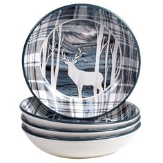 three white and blue dishes with deer silhouettes in the woods on each one, sitting side by side