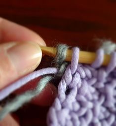 someone is crocheting together with yarn on the table