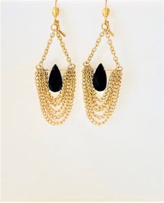 "Showstopper gold finished steel and black acrylic teardrop earrings! Wear these when you want your earrings to take center stage! Each teardrop is surrounded by 5 graduated chains, giving the earrings their original look. They are not as heavy as they appear, but you will know you are wearing large earrings.  I topped them off with brass plated lever-back ear wires for extra security. Measure 4.25\" long and 1.25\" wide. Please note that due to lighting effects and monitor settings, there might Metal Teardrop Earrings For Evening, Pierced Teardrop Earrings For Evening, Black Jewelry With Gold Chain For Evening, Evening Black Jewelry With Gold Chain, Gold Metal Teardrop Earrings For Evening, Black Teardrop Metal Jewelry, Black Metal Drop Earrings, Black Dangle Earrings With Chain, Black Chain Dangle Earrings