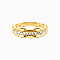 a yellow gold ring with three rows of diamonds on the inside and outside, set against a white background