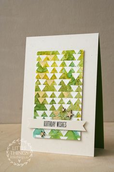 a handmade birthday card with green and yellow triangles on it, which reads happy birthday wishes