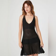 A Sheer Crochet Mini Dress Featuring A V-Neckline, Y-Back With Knotted Detail, Bust Lining, Scalloped Handkerchief Hem, And Flowy Silhouette. - Layering Garments Not Included. Chic V-neck Crochet Dress For Day Out, Fitted V-neck Crochet Summer Dress, Stretch Crochet V-neck Dress For Vacation, Black V-neck Crochet Dress For Summer, Black Fitted V-neck Crochet Dress, Casual V-neck Crochet Dress For Party, Fitted Black Crochet Beachwear Dress, Summer Stretch Crochet Dress With V-neck, Fitted Black Crochet Dress For Beachwear