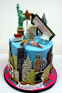 a birthday cake decorated with the statue of liberty and new york cityscape on top