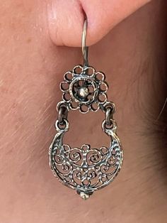 We are excited to feature a collection of Mexican Silver Filigree Earrings from Oaxaca in our store. Each piece is crafted from molten silver, processed and formed into intricate designs, often adorned with exquisite stones. Our artisans, with their skilled hands, create unique pieces that encapsulate a stunning and romantic aesthetic. Adorning these pieces, you're not just wearing jewelry; you're embodying a special, timeless elegance. Materials:  Oxidized Pure 92.5 Sterling Silver Gemstone: Malachite Drop Length: 1 1/2" long, 3/4" wide Closure: Ear Wire Traditional Silver Oval Earrings, Unique Dangle Earrings With Intricate Design, Traditional Teardrop Pierced Earrings, Unique Drop Earrings With Intricate Design, Artisan Earrings With Intricate Design For Gift, Artisan Drop Earrings With Intricate Design, Unique Intricate Design Dangle Earrings, Artisan Dangle Earrings With Intricate Design, Artisan Nickel Free Drop Earrings