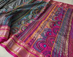 Here we bring a gorgeous Grey Pure Ilkal Silk Lambani Handwork Saree. The palla and border are adorned with beautiful Lambani embroidery with colourful threads and mirrors. This Saree comes with embroidered blouse piece. Please swipe left to see all the pictures and the last picture is of the blouse piece.   About Lambani Handwork: Lambada or Lambani embroidery is an art of embellishing clothes practiced by the Lambadas or Lambanis, the tribe in Sanduru, Karnataka. Lambada embroidery uses a comb Anarkali Tussar Silk Dupatta With Mirror Work, Traditional Tussar Silk Wear With Mirror Work For Navratri, Tussar Silk Traditional Wear With Mirror Work For Navratri, Multicolor Bohemian Traditional Wear For Designer Occasions, Festive Tussar Silk Dupatta With Mirror Work, Bollywood Style Tussar Silk Traditional Wear With Mirror Work, Tussar Silk Dupatta With Mirror Work For Navratri, Embroidered Paithani Silk Choli For Festive Season, Festive Embroidered Paithani Silk Choli