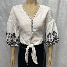 Cute Embroidery Oversized Front Tie Top For The Office Or With Jeans On The Weekend. 19” Armpit To Armpit White Half Sleeve Blouse For Brunch, White Cotton Blouse With 3/4 Sleeves, White Floral Embroidered 3/4 Sleeve Blouse, White Blouse With Floral Embroidery 3/4 Sleeve, White Embroidered Relaxed Fit Top, White 3/4 Sleeve Tops For Vacation, White Embroidered Blouse With 3/4 Sleeves, Spring Embroidered Cotton Top With 3/4 Sleeves, Embroidered Tops With 3/4 Sleeve For Vacation