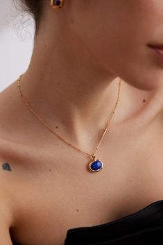 Sophisticated Blue Necklace with Gold-Framed Oval Lapis Lazuli Blue Lapis Lazuli Oval Jewelry, Elegant Blue Necklace With Delicate Chain, Elegant Blue Jewelry With Delicate Chain, Elegant Blue Oval Cabochon Necklace, Elegant Blue Round Pendant Necklace, Formal Blue Oval Pendant Necklace, Classic Blue Round Pendant Necklace, Blue Oval Gemstone Necklace, Classic Blue Pendant Necklace