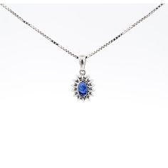 Item Details: - Type: Drop Pendant Necklace  - Metal: 18K White Gold  - Weight: 1.05 Grams (pendant only) - Setting: Prong, Halo ______________________________  Center Stone Details: - Type: Natural Sapphire  - Carat: 1.20  - Cut: Oval  - Color: Blue  - Measurements: 6.5 X 5 MM  ______________________________  Side Stone Details:  - Type: Natural Diamond  - Cut: Round  - Color: G-H - Clarity: SI1-SI2 - Quantity: 14  ______________________________  Dazzling modern drop pendant necklace, featuring a 1.20 carat natural oval cut Sapphire radiating a deep royal blue. This center stone is matched with 14 piece round-cut diamond halo in a star motif pendant made of 18K white gold. Set with an open back to allow for the center stone's natural color to be on full display.   The default order comes Oval Blue Diamond Necklaces, Blue Oval Diamond Necklaces, Blue Diamond Oval Pendant Necklace, Oval Sapphire Necklace With Brilliant Cut, Sapphire Diamond Oval Cabochon Jewelry, Blue Diamond Oval Pendant Jewelry, Blue Sapphire Jewelry In Oval Cabochon Shape, Sapphire Diamond Jewelry In Oval Cabochon Shape, Sapphire Oval Necklace With Diamond Cut