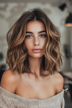 A woman with wavy shoulder-length hair wearing an off-shoulder sweater. Hair Colour Ideas Caramel, Chocolate Honey Hair Color, Chocolate Hair With Balayage, Brunette Balayage Hair Golden Blonde, Low Damage Hair Color, Strawberry Blonde Brown Balayage, Mid Length Caramel Balayage, Gold Honey Hair, Brown And Honey Hair