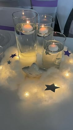 candles are lit in the middle of a cloud with stars on it