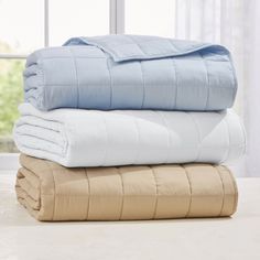 three blankets stacked on top of each other