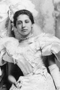 an old black and white photo of a woman in a wedding dress