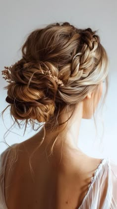 a woman with braids in her hair wearing a white dress and looking off to the side