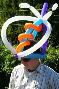 a man wearing a hat made out of balloons