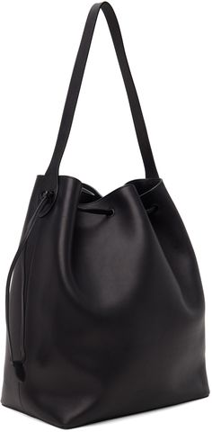 Polished saddle calfskin tote in black. · Fixed shoulder strap · Gold-tone logo stamp at side · Drawstring closure · Zip and patch pocket at interior · H14.5 x W12 x D7 Supplier color: Black Black Calf Leather Shoulder Bag With Smooth Grain, Black Calf Leather Shoulder Bag With Detachable Strap, Black Calf Leather Shoulder Bag For Travel, Classic Smooth Grain Bucket Bag For Work, Black Calf Leather Bucket Bag With Adjustable Strap, Black Calf Leather Bag With Detachable Strap, Black Calf Leather Shoulder Bag, Black Calf Leather Shoulder Bag For Everyday, Everyday Black Calf Leather Shoulder Bag