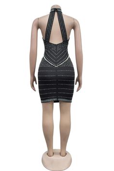 a mannequin wearing a black and white dress with beading on the back