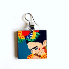 100% Hand Painted Frida Earrings, and made from scratch. Every single element such as metal jump rings, wood and hook earring findings was assembled by hand. Original Artwork. No Prints. This gorgeous hand painted Frida earrings are a beautiful mini masterpiece. Original Artwork. We created them using high quality acrylic paint which had been protected with a special gloss coat to ensure its durability.Very light to wear and one of a kind accessory. It's the perfect gift for that very special pe Artistic Hand Painted Turquoise Jewelry, Artistic Hand-painted Turquoise Jewelry, Artsy Turquoise Nickel-free Earrings, Artsy Nickel-free Turquoise Earrings, Artistic Single Earring For Gift, Quirky Blue Jewelry For Gifts, Quirky Blue Jewelry For Gift, Hand Painted Turquoise Drop Earrings, Artistic Hand Painted Earrings For Gifts