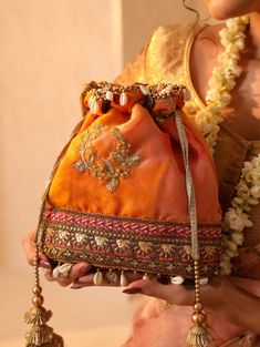 About This Item Introducing THE TAN CLAN Embroidered Embellished Potli Bag--a premium accessory designed to elevate your style for any special occasion. This luxurious drawstring purse is the perfect addition to your collection, ideal for weddings, festive celebrations, Diwali, New year, Christmas, bridesmaid, anniversary, engagements, baby shower and other significant events. Description: THE TAN CLAN Embellished Potli Clutch | Premium Women Pouch | Elegant Wedding Purse for Girls | Luxurious Drawstring Purse for Special Occasions *Material: Crafted from high-quality fabric, this potli clutch boasts a rich, opulent texture that complements its exquisite design. The premium materials ensure both durability and a luxurious feel. *Design: Adorned with intricate embellishments that shimmer an Traditional Potli Pouch Bag, Traditional Handmade Potli Bag For Festivals, Traditional Zari Work Potli Bag As Gift, Traditional Pouch Potli Bag For Diwali, Traditional Festival Potli Pouch Bag, Bohemian Gold Potli Bag With Dori Work, Traditional Handmade Pouch For Diwali, Gold Bohemian Potli Bag With Dori Work, Traditional Handmade Festive Pouch