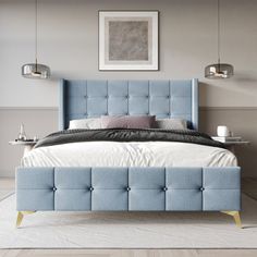 a bed with blue upholstered headboard and foot board in a bedroom setting