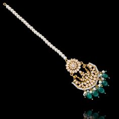 This regal set befitting a queen's closet, pays tribute to Mughal royalty and is the classiest way to embrace the festive season! A charmingly curated set, intricately detailed with the rich emerald drops and garnished with lush CZ and faux pearl beads. Approximate earrings length is 2.5". This set is available in 4 options: Necklace + Earrings Necklace + Earrings + Teekah Necklace + Earrings + Teekah + Jhoomar/passa Necklace + Earrings + Teekah + Jhoomar + Finger Ring Please select the desired Unique Gift Cards, Heritage Jewellery, Create Words, Waist Chain, Faux Stone, Head Accessories, Finger Ring, Festive Season, Necklace Earrings