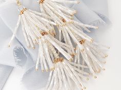 "NEW & WE ARE IN LOVE with these chic hand-beaded tassel wedding earrings, perfect for the boho bride at heart and a fun accessory to wear after the wedding too! Each piece is made in the USA. DETAILS *As shown, earrings feature soft white hand beaded tassels *The earrings measure about 4\" top to bottom and about 1\" wide *Finish is available in gold as shown The goal of your earrings is to compliment your dress and your overall wedding day look, not overpower it. We want our earrings to ma Statement Wedding Earrings, Boho Wedding Earrings, Earrings For Bride, Bridal Jewellery Earrings, Statement Earrings Wedding, Earrings For Wedding, Augusta Ga, After The Wedding, Earrings Beaded