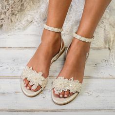 a close up of a person's feet wearing wedding shoes with flowers on them