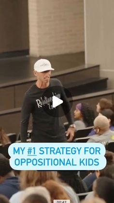 a man standing in front of an audience with the words my 1 strategy for propositional kids