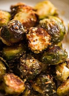 brussel sprouts with garlic and parmesan cheese are piled on top of each other