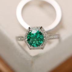 This ring features a 7mm round lab emerald and sterling silver finished with rhodium. Customization is available. It is made by hand, and it will take about 7 days to finish the ring after your payment is completed. Main stone: lab emerald Main stone weight: Approx 1.10 ct Metal type: sterling silver finished with rhodium Accent stone: cz Customization is available, I also can make it with 14k solid gold (white or yellow or rose) and diamond accent stone, just feel free to contact me. Any questi Cathedral Wedding Ring, Emerald Ring Engagement, Cushion Cut Halo Ring, Black Spinel Ring, Pear Cut Ring, May Birthstone Rings, Green Gemstone Ring, Green Emerald Ring, Cathedral Wedding